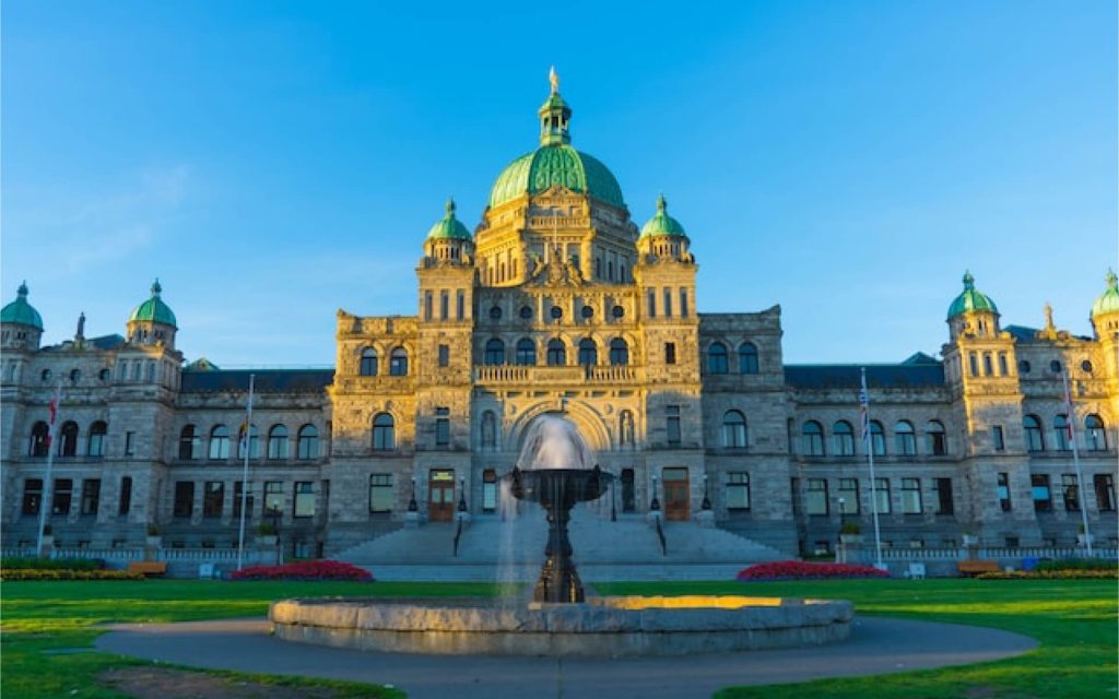 BC Legislature building and fountain on a clear day.