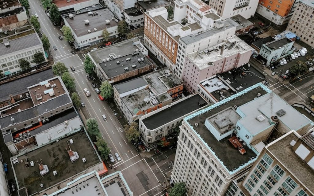 Aerial view of commercial buildings lining a street.